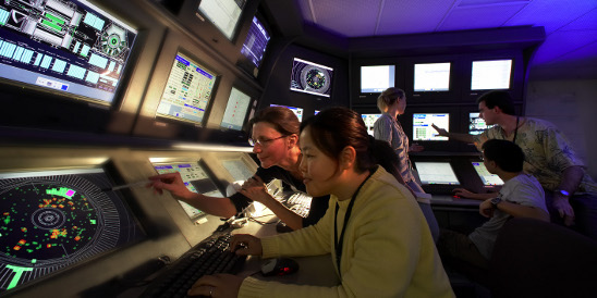Stanford Physics Professor Pat Burchat and student Ho Jeong Kim in the BaBar main control room.